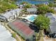 Aerial view showing the tennis court and pool area for the community, near a lake at 1017 S Hiawassee Rd # 3718, Orlando, FL 32835