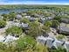 Scenic aerial view showcases a condo community with lake views, mature trees, and ample parking at 1017 S Hiawassee Rd # 3718, Orlando, FL 32835