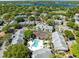 Aerial view showcasing the community amenities like a pool and tennis court, nestled near a lake at 1017 S Hiawassee Rd # 3718, Orlando, FL 32835