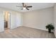 Bright bedroom featuring a ceiling fan, carpeted floors, and an en-suite bathroom for added convenience at 1017 S Hiawassee Rd # 3718, Orlando, FL 32835