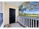 Charming outdoor patio features a dark door and white railing, perfect for relaxing outdoors at 1017 S Hiawassee Rd # 3718, Orlando, FL 32835