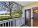 Outdoor patio with white railings and a view of lush green trees and shrubbery, providing a serene ambiance at 1017 S Hiawassee Rd # 3718, Orlando, FL 32835