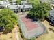 Community tennis court surrounded by trees and landscaping at 1017 S Hiawassee Rd # 3718, Orlando, FL 32835