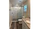 Bathroom with a glass-enclosed shower and modern tiling at 120 S Chandler Ave, Deland, FL 32724