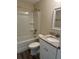 Bright bathroom features a shower-tub combination with a granite countertop sink at 120 S Chandler Ave, Deland, FL 32724