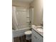 Well-lit bathroom features a shower-tub combination and granite countertop vanity at 120 S Chandler Ave, Deland, FL 32724