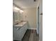 Bathroom with granite countertops, double sinks, and modern lighting fixtures at 120 S Chandler Ave, Deland, FL 32724