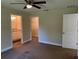 Spacious bedroom offering great natural light, ceiling fan, and ensuite bathroom and walk-in closet at 120 S Chandler Ave, Deland, FL 32724