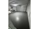 Spacious garage with speckled epoxy flooring and ample cabinet storage at 120 S Chandler Ave, Deland, FL 32724