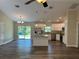 Kitchen area features stainless steel appliances, granite countertops, island and wood grain floors at 120 S Chandler Ave, Deland, FL 32724