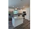 Modern kitchen featuring stainless steel appliances, granite countertops, a central island, and pendant lighting at 120 S Chandler Ave, Deland, FL 32724