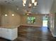 Large living room boasting hard surface floors, and stylish lighting fixtures, with view of island and kitchen at 120 S Chandler Ave, Deland, FL 32724