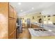 Spacious kitchen featuring wood cabinets, stainless steel appliances, and granite countertops at 130 Hillside Dr, Davenport, FL 33897