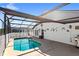 Enclosed pool with an open design and seating. The lanai features white lattice and sun protection at 130 Hillside Dr, Davenport, FL 33897