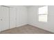 Well-lit bedroom featuring a window and a closet with sliding doors for ample storage at 13405 Sw 88Th Ter # 53, Ocala, FL 34473