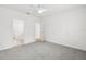 Spacious bedroom with neutral walls and carpet, offering a glimpse into the bathroom and hallway at 13405 Sw 88Th Ter # 53, Ocala, FL 34473