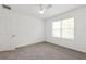 Bright bedroom featuring neutral carpet, a ceiling fan, and natural light from a window with blinds at 13405 Sw 88Th Ter # 53, Ocala, FL 34473