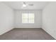 Bright bedroom featuring neutral carpet, a ceiling fan, and natural light from a window with blinds at 13405 Sw 88Th Ter # 53, Ocala, FL 34473