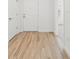 Bright hallway featuring a white door and attractive wood-look flooring at 13405 Sw 88Th Ter # 53, Ocala, FL 34473