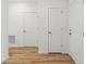 Bright hallway featuring white doors and attractive wood-look flooring at 13405 Sw 88Th Ter # 53, Ocala, FL 34473