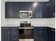 Modern kitchen featuring dark cabinets, countertops and stainless steel appliances at 13405 Sw 88Th Ter # 53, Ocala, FL 34473