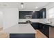 Contemporary kitchen featuring navy blue cabinets, stainless steel appliances, and a large island at 13405 Sw 88Th Ter # 53, Ocala, FL 34473