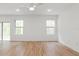Spacious, bright living room with stylish flooring and ample natural light from the windows at 13405 Sw 88Th Ter # 53, Ocala, FL 34473