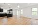 Open concept living space featuring wood-look tile flooring, black kitchen cabinets, and stainless steel appliances at 13405 Sw 88Th Ter # 53, Ocala, FL 34473