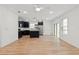 Open concept living space featuring kitchen with island, stainless steel appliances, and wood-look tile flooring at 13405 Sw 88Th Ter # 53, Ocala, FL 34473