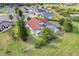 An aerial view of a property featuring a screened pool, a lush green lawn, and well-maintained landscaping at 13542 Texas Woods Cir, Orlando, FL 32824