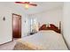 A cozy bedroom with floral quilt and an adjacent bathroom at 13542 Texas Woods Cir, Orlando, FL 32824