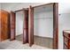 View of an open closet showing the interior and wooden doors at 13542 Texas Woods Cir, Orlando, FL 32824