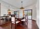 Elegant dining room with hardwood floors, mirrored wall, and sliding door access to the pool at 13542 Texas Woods Cir, Orlando, FL 32824