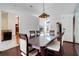 Dining room featuring hardwood floors, light fixture and open access to the kitchen at 13542 Texas Woods Cir, Orlando, FL 32824