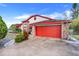 Charming two-story home featuring a vibrant red garage door and brick accents at 13542 Texas Woods Cir, Orlando, FL 32824