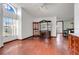 Living room featuring hardwood floors, ample natural light, and elegant display cabinets at 13542 Texas Woods Cir, Orlando, FL 32824