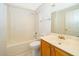 Bathroom features a shower-tub combo, toilet, and a single sink vanity at 142 Barrington Dr, Kissimmee, FL 34758