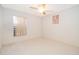 A well-lit bedroom with tile flooring, ceiling fan, and a window at 142 Barrington Dr, Kissimmee, FL 34758