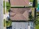 Overhead view of a home's roof and backyard, with an outdoor seating area and manicured lawn at 14228 Portrush Dr, Orlando, FL 32828