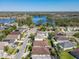 Scenic aerial shot of a community with waterfront views and lush landscaping with mature trees and lake at 14228 Portrush Dr, Orlando, FL 32828