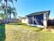 Well-maintained backyard featuring lush green grass and a screened lanai perfect for outdoor relaxation at 14228 Portrush Dr, Orlando, FL 32828