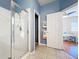 Bathroom with walk-in shower, blue walls, and access to the main bedroom at 14228 Portrush Dr, Orlando, FL 32828