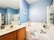 Bathroom features a large soaking tub with tile surround and a single vanity at 14228 Portrush Dr, Orlando, FL 32828