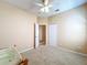 Neutral bedroom offers a ceiling fan, carpet, closet, and window with blinds at 14228 Portrush Dr, Orlando, FL 32828