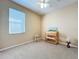 Carpeted bedroom features a window with blinds, ceiling fan, and furnishings at 14228 Portrush Dr, Orlando, FL 32828