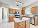 Bright kitchen featuring stainless steel appliances, center island, and modern lighting fixtures at 14228 Portrush Dr, Orlando, FL 32828