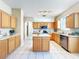 Wide view of the kitchen with island, stainless steel appliances and tile flooring at 14228 Portrush Dr, Orlando, FL 32828