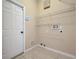 Tiled laundry room features wire shelving and hook-ups at 14228 Portrush Dr, Orlando, FL 32828