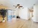 Spacious living room featuring wood floors and sliding glass doors to the covered patio at 14228 Portrush Dr, Orlando, FL 32828