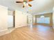 Cozy living room with wood flooring, ceiling fan, and a bright window for natural light at 14228 Portrush Dr, Orlando, FL 32828